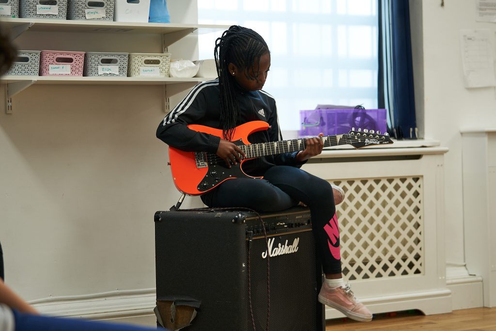 Student playing the guitar